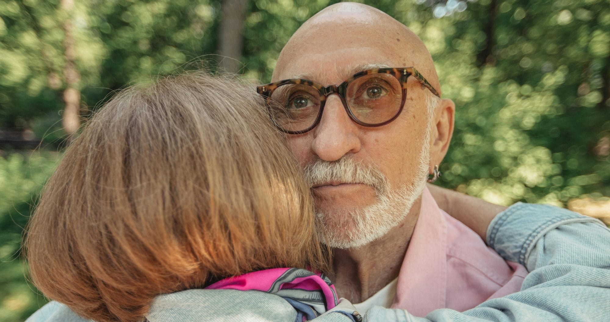 Elder couple embracing, pondering the future